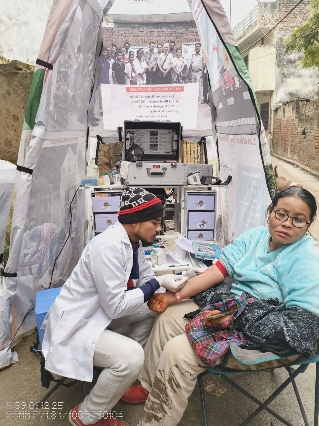 Health worker checking a patient beside the LaBike diagnostic unit